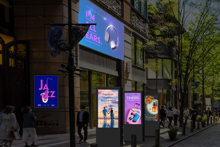 This image highlights digital signage in an outdoor space, displaying a range of ads covering topics like music, travel, and beauty.